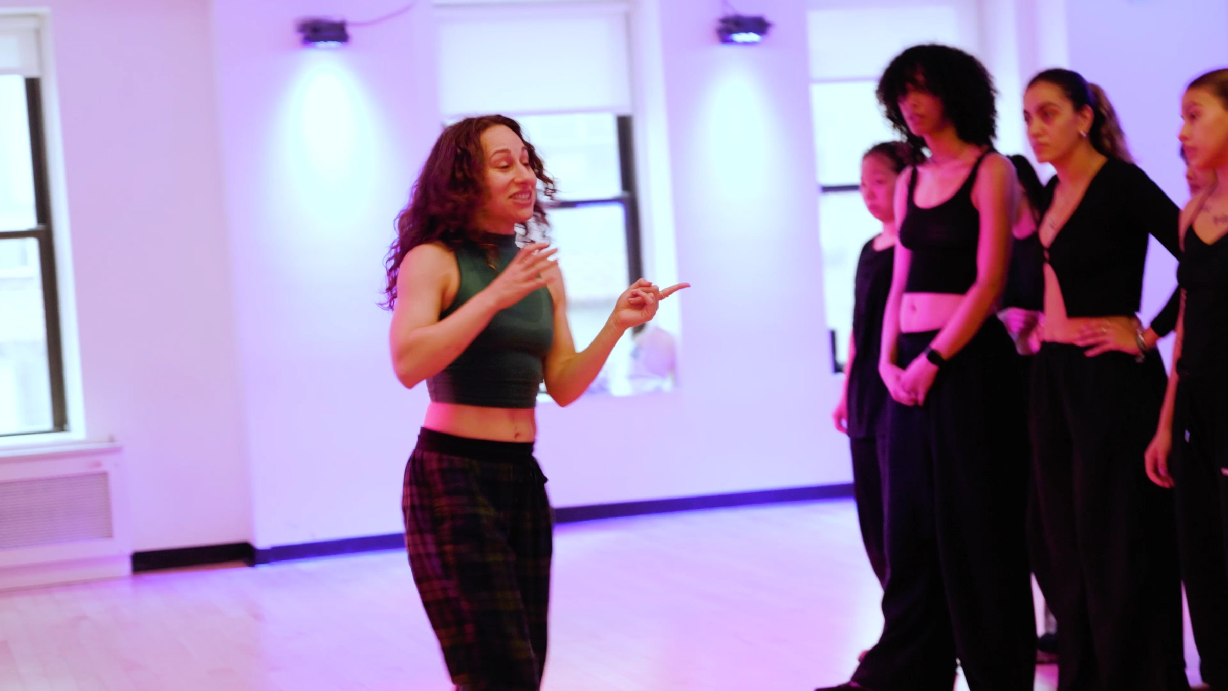 Galit Friedlander smiling mid count in front of a room at Broadway Dance Center